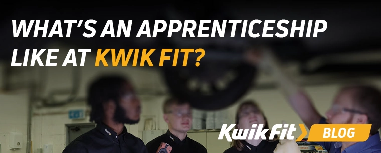 Apprentices at work under a car